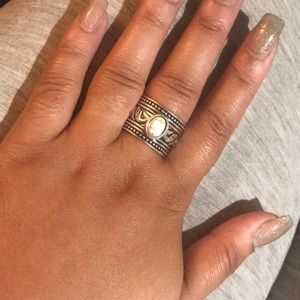 Silver ring with white stone in the middle